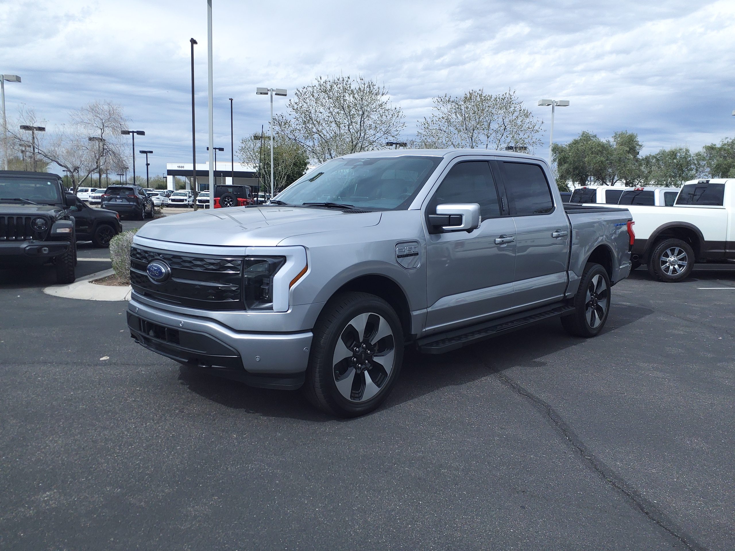 Ford F-150 Lightning electric pickup in dealership lot representing small-battery EV concept